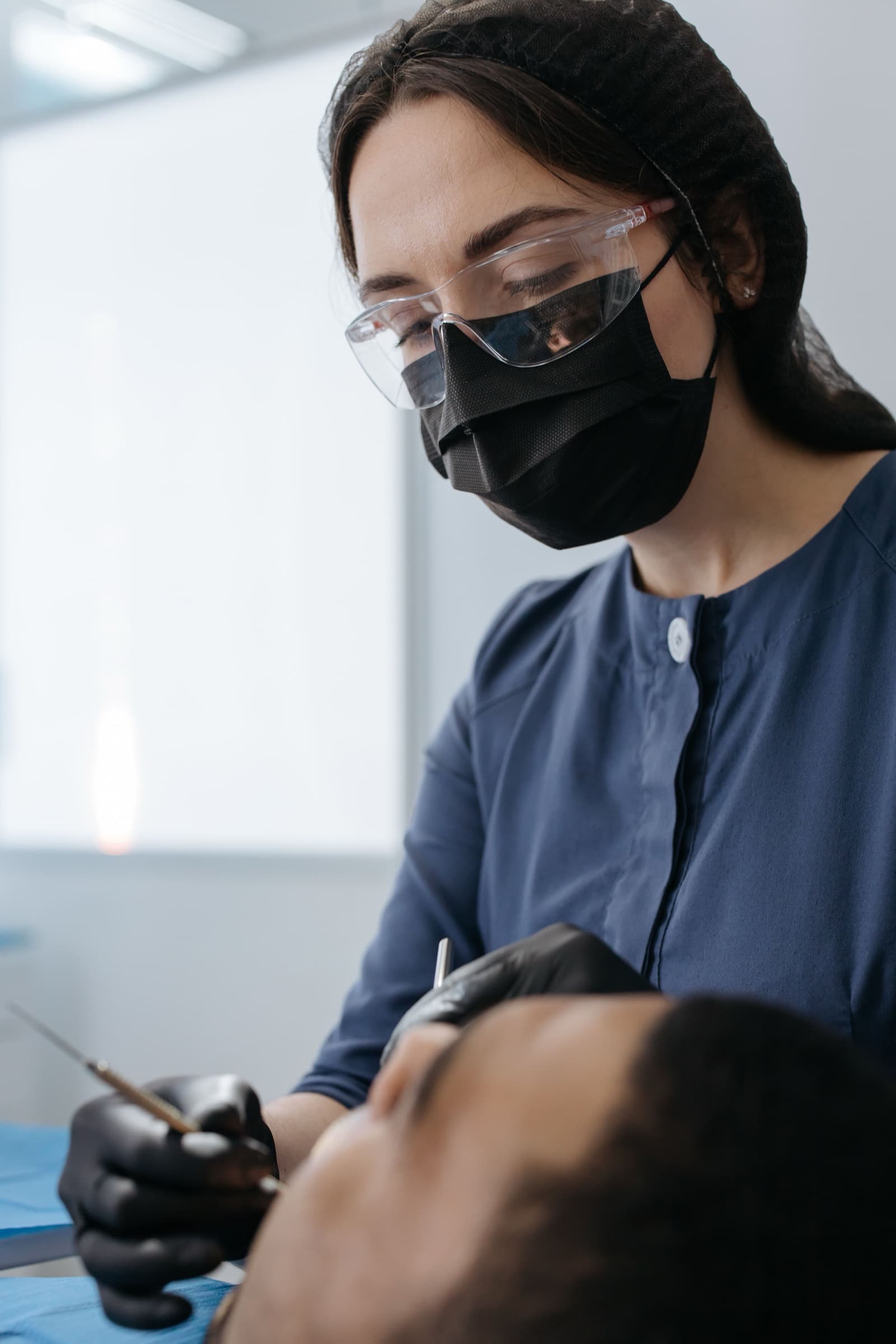 A dentist at Echo Bloom Dental treating a patient