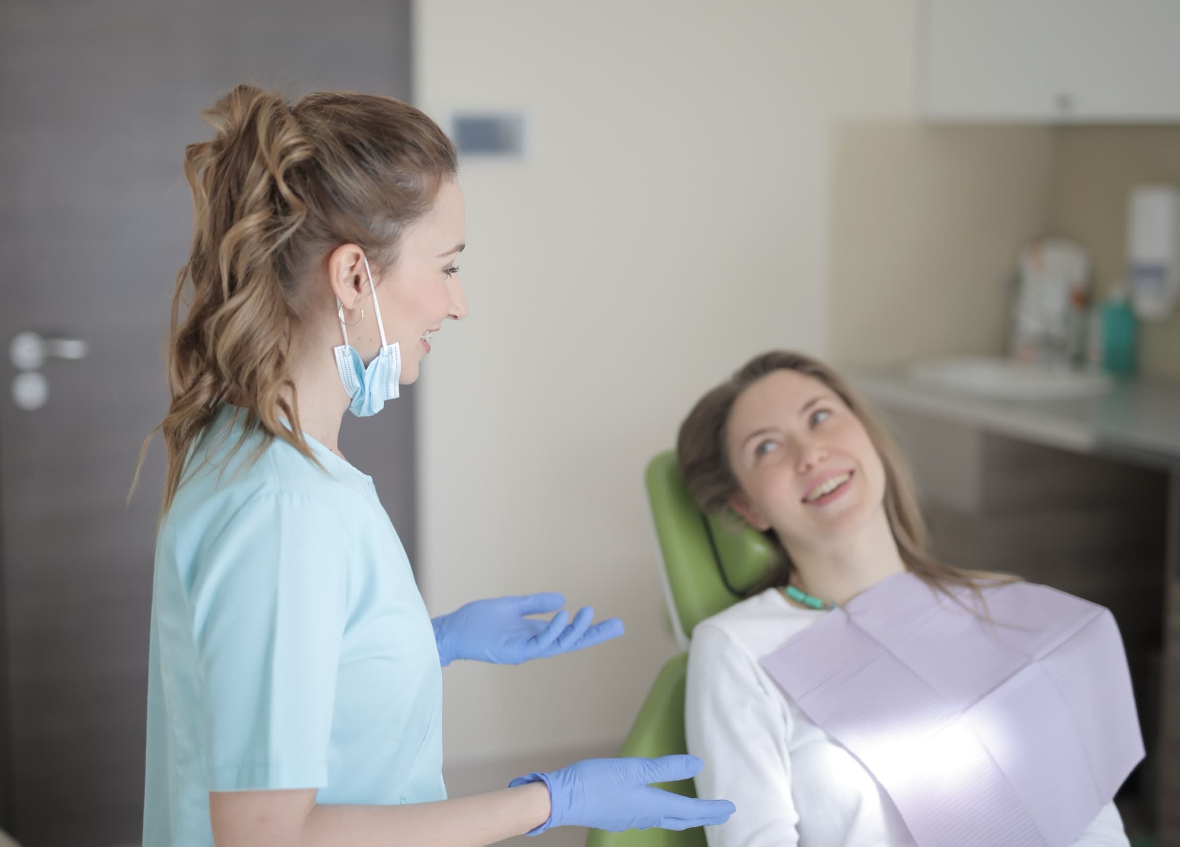 A dentist talking with a patient before treatment